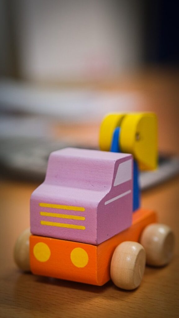 selective focus photography of orange and purple block car toy